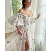 Vestido largo de fiesta con escote barco, abertura lateral y bolsillos.