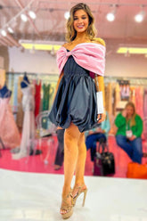 Lindo vestido corto negro de corte A con hombros descubiertos y lazo, ideal para fiestas de bienvenida.