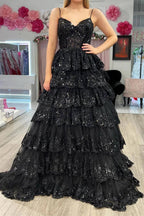 Vestido de fiesta negro de encaje con corsé, tirantes finos y corte en A, con volantes y tirantes finos.