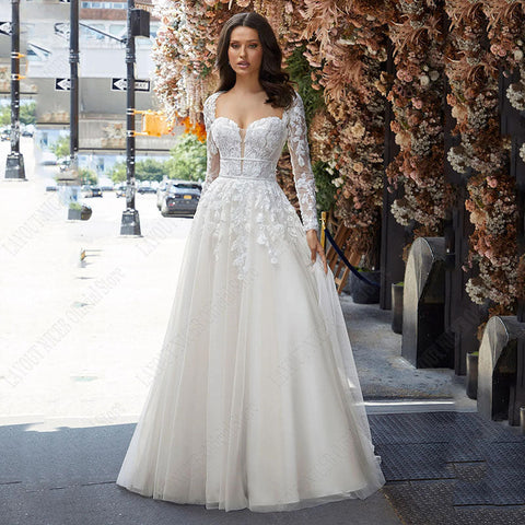 Vestido de novia corte A, manga larga desmontable, elegante, espalda descubierta, encaje, apliques de tul. 