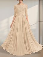Robe de mère de la mariée en mousseline de soie et dentelle, coupe trapèze, longueur au sol, décolleté illusion, ornée de sequins plissés