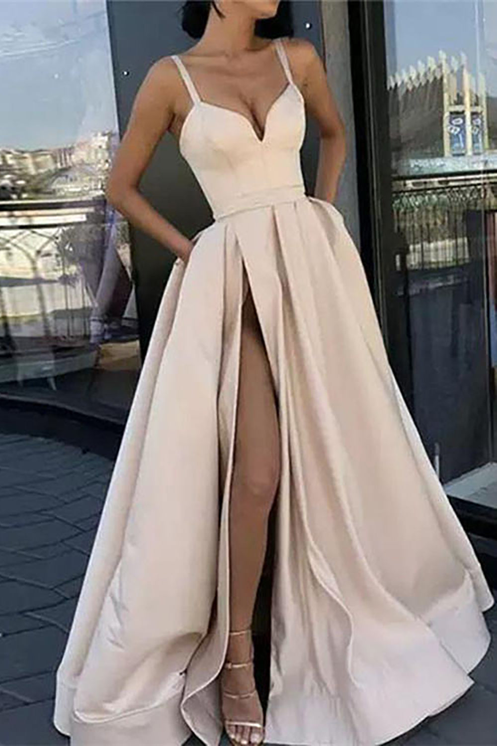 Vestido largo de fiesta negro de corte A con tirantes finos y falda asimétrica.