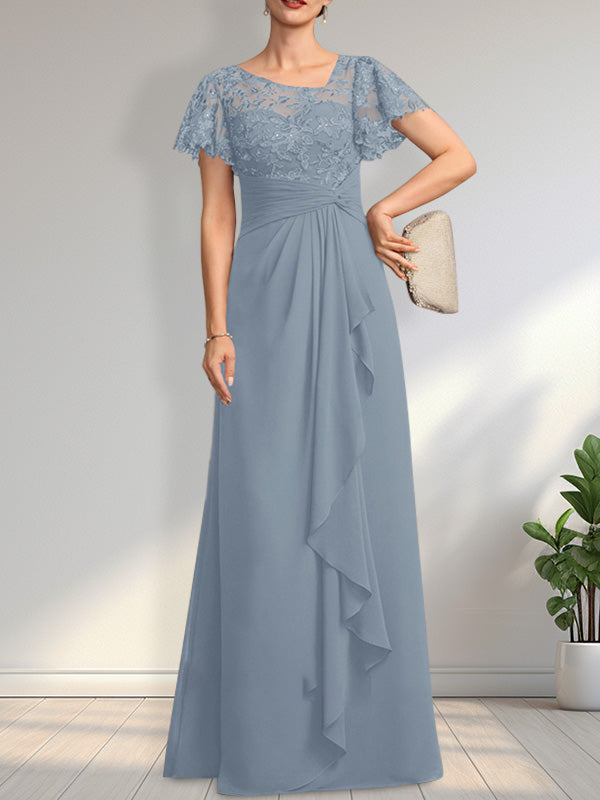 Vestido de novia de corte asimétrico, ilusión, largo hasta el suelo, de encaje y gasa, con cascada de volantes y lentejuelas. 