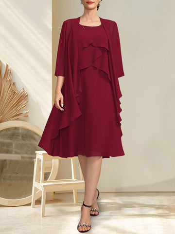 Vestido de gasa corte A con escote redondo y largo hasta la rodilla para la madre de la novia, con pedrería.