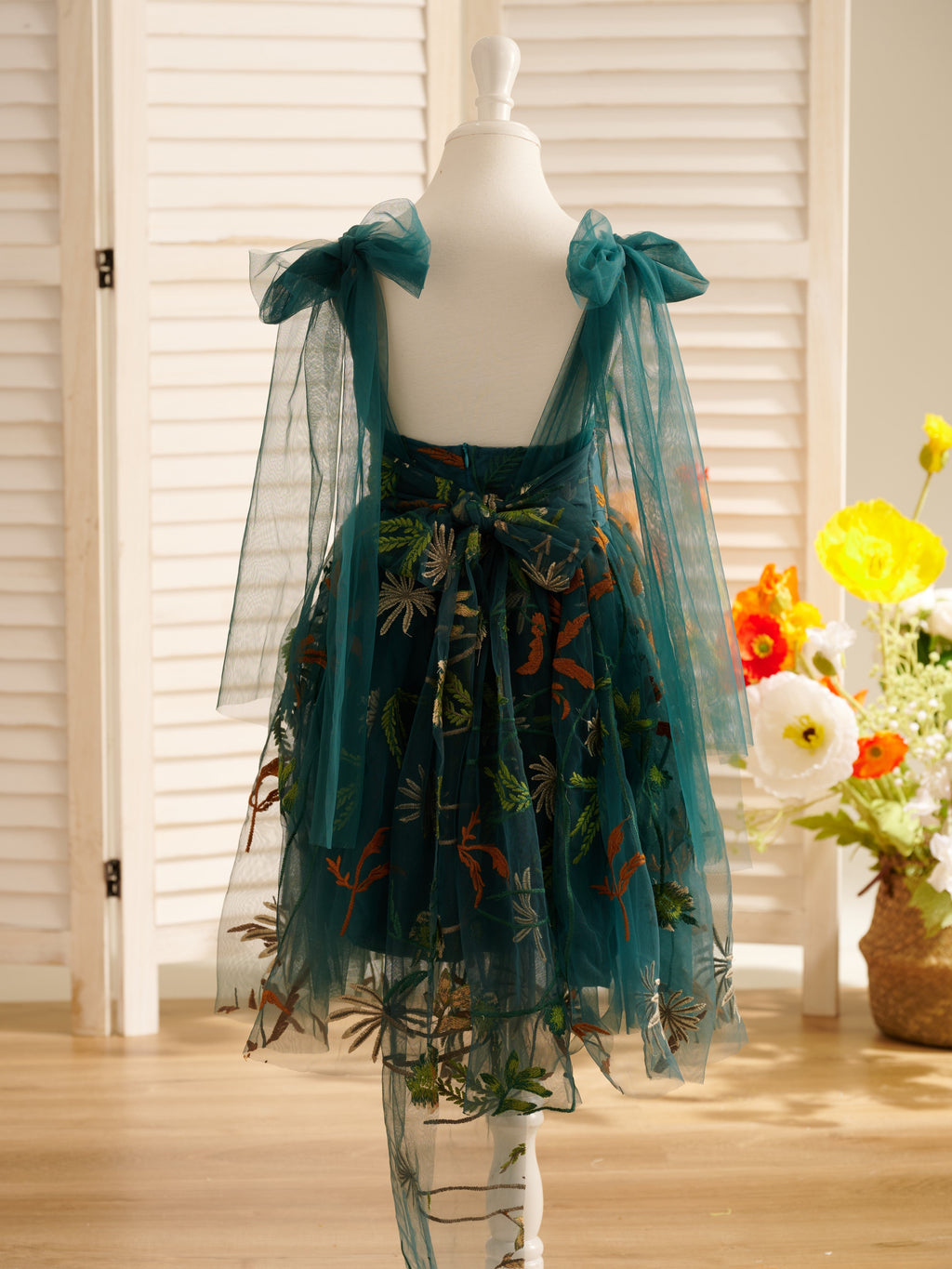 Vestido de niña pequeña hasta la rodilla, de encaje y tul color naranja quemado con bordados. 