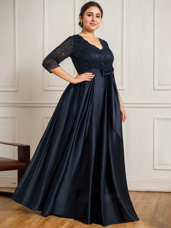 Vestido de novia de satén con encaje, corte en A, escote en V y largo hasta el suelo, con lazo de lentejuelas. 