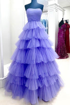 Vestido largo de fiesta rosa fucsia sin tirantes, corte en A y con volantes