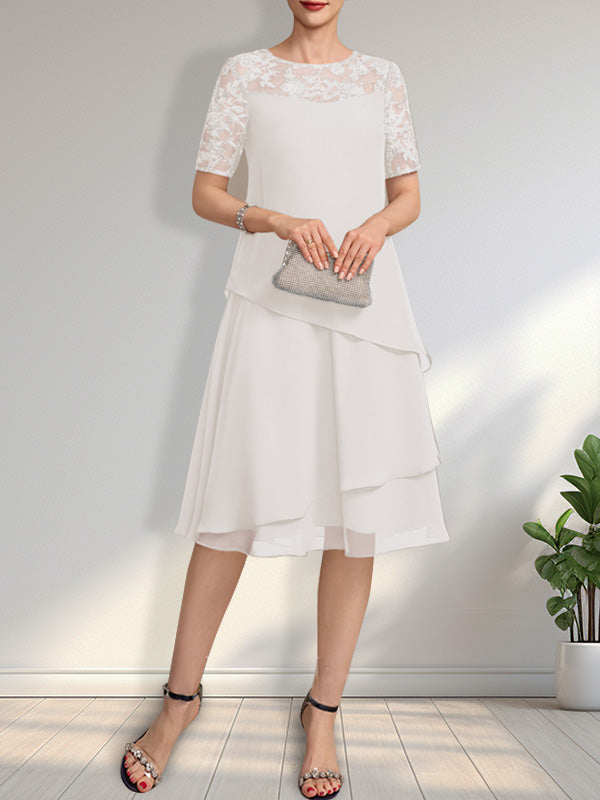 Vestido de novia de corte línea A con escote ilusión, largo hasta la rodilla, de encaje y gasa con lentejuelas.