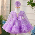 Vestido de bebé niña color lila con lentejuelas, mangas largas con volantes y lazo hasta la rodilla 