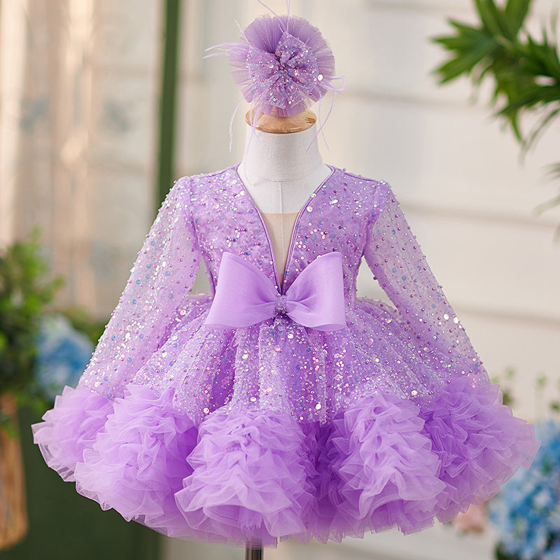 Vestido de bebé niña color lila con lentejuelas, mangas largas con volantes y lazo hasta la rodilla 