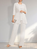 Vestido de novia de gasa con encaje y lentejuelas, estilo mono/traje pantalón, largo hasta el suelo, con escote redondo.