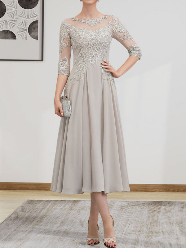 Robe de mariée trapèze en mousseline de soie et dentelle, longueur thé, ornée de perles et de sequins, avec décolleté en A et effet illusion.