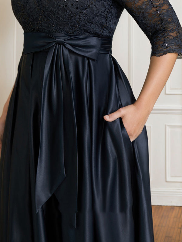 Vestido de novia de satén con encaje, corte en A, escote en V y largo hasta el suelo, con lazo de lentejuelas. 
