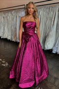 Robe de bal longue bustier métallisée froncée, coupe trapèze, avec nœud