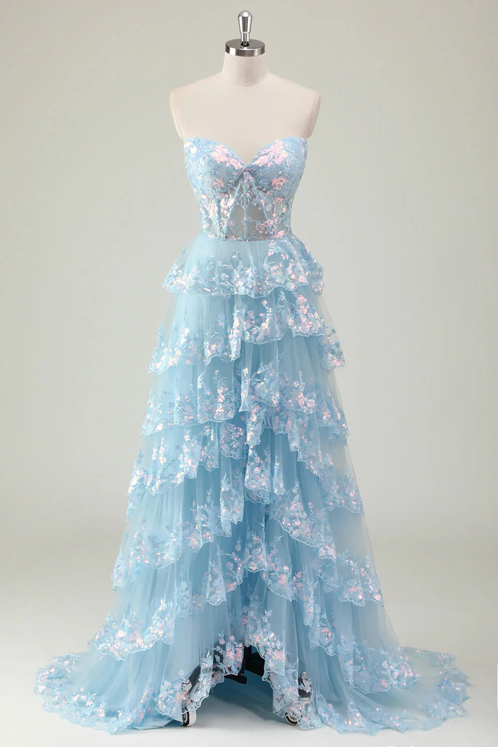Robe de bal longue à sequins scintillants, coupe trapèze, bustier à volants et fente.