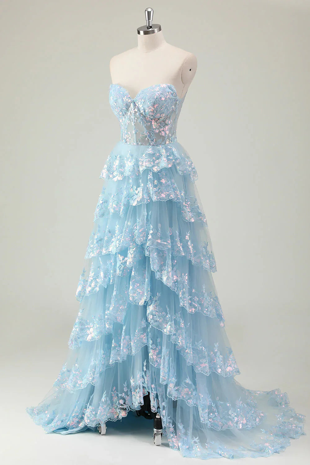 Robe de bal longue à sequins scintillants, coupe trapèze, bustier à volants et fente.