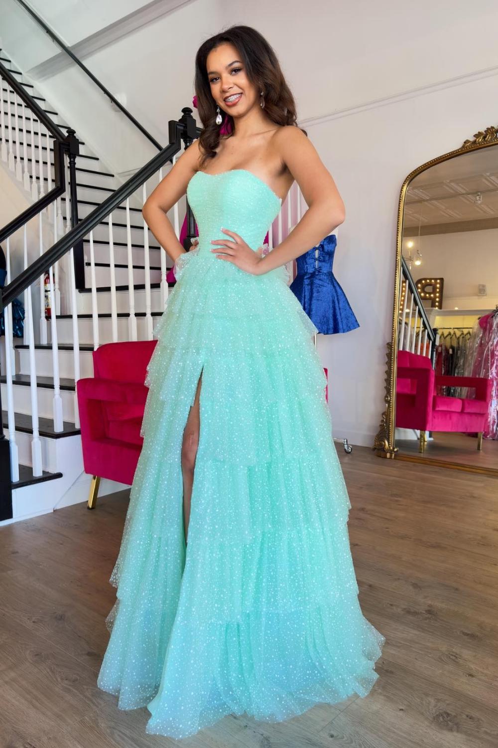 Robe de bal longue trapèze en tulle à volants et décolleté cœur, avec fente.