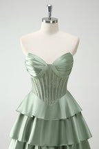 Robe de bal longue vert pailleté coupe trapèze à corset à volants