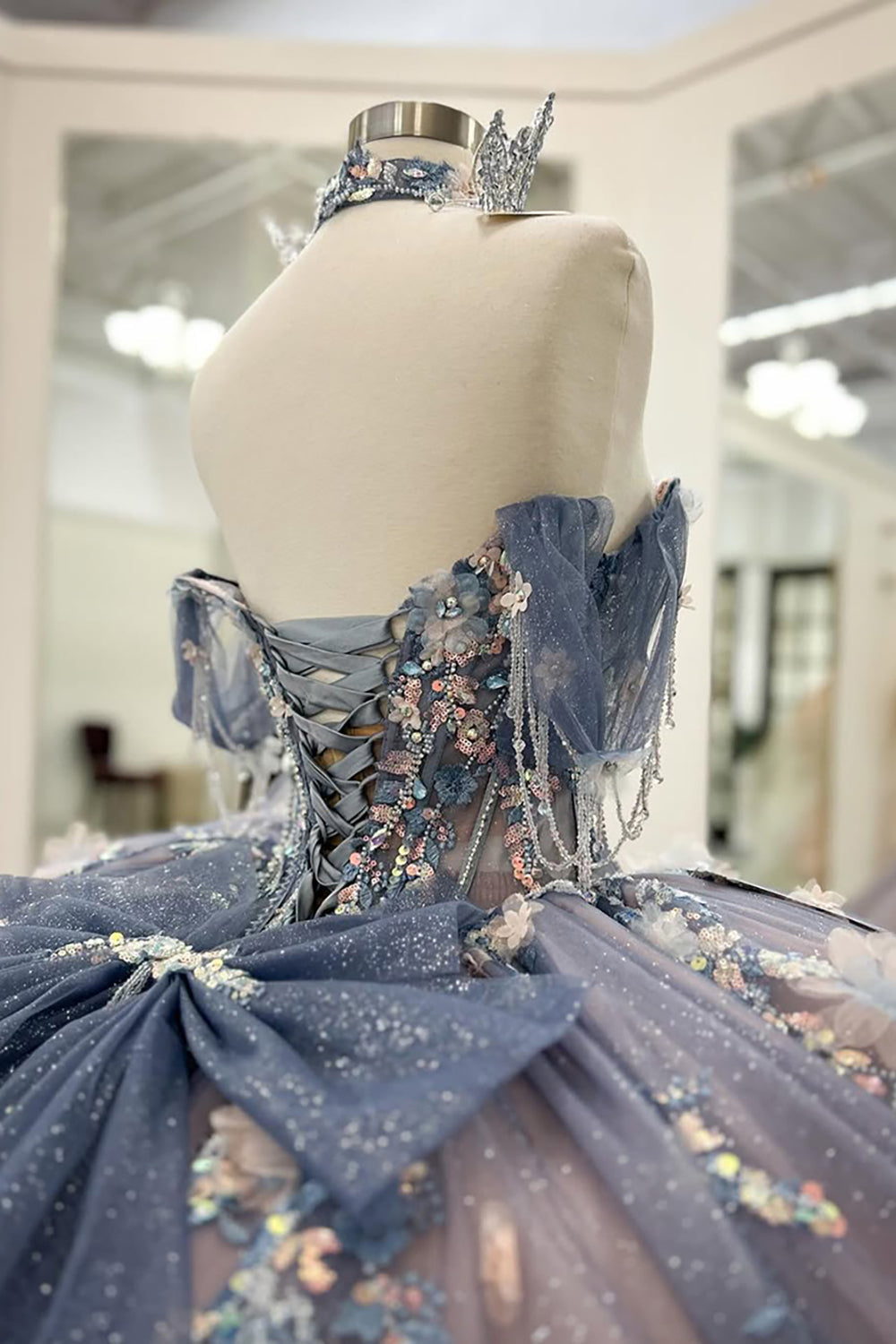 Robe de bal de quinceañera gris-bleu scintillante, épaules dénudées, ornée d'appliqués et avec traîne.