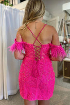 Magnifique robe fourreau fuchsia courte à épaules dénudées avec plumes.