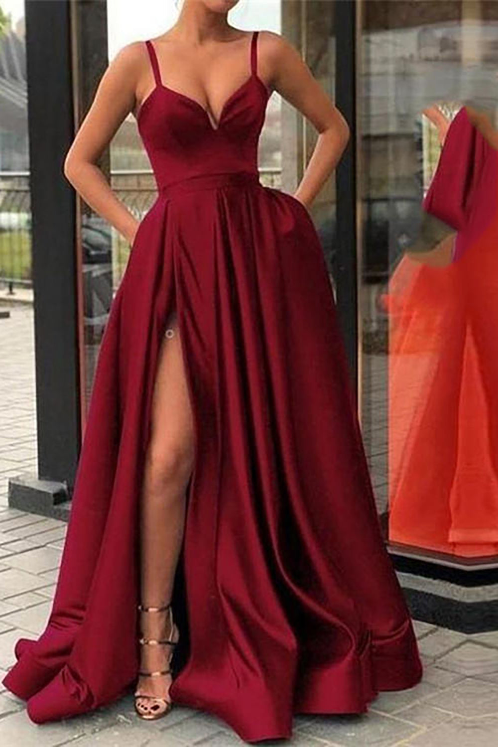 Vestido largo de fiesta negro de corte A con tirantes finos y falda asimétrica.