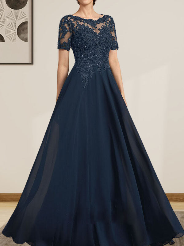 Robe de mariée longue en mousseline de soie et dentelle, coupe trapèze, décolleté illusion, ornée de sequins et de perles.