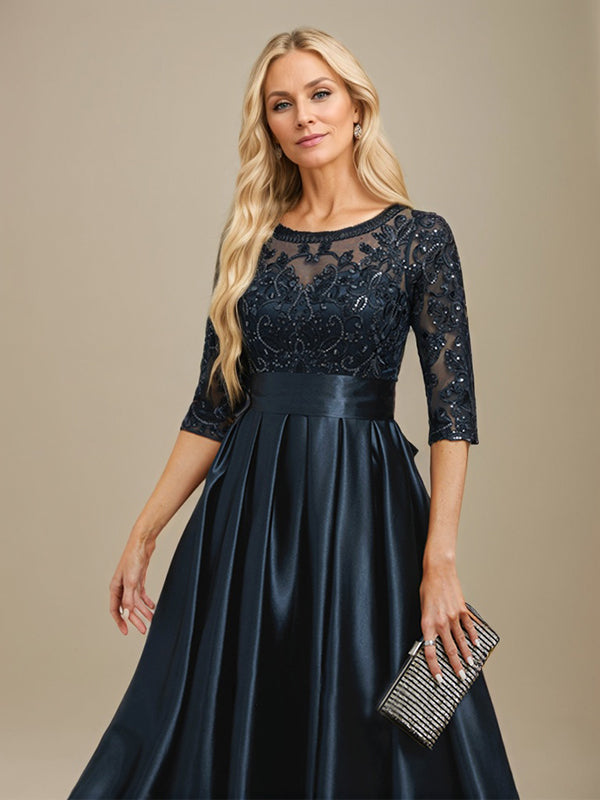 Robe de mariée longue en satin stretch dentelle et dentelle, coupe trapèze, décolleté illusion, ornée d'un nœud à sequins 