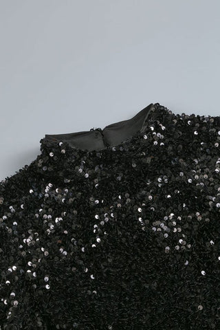 Vestido largo de noche con lentejuelas, cuello alto simulado, manga larga y abertura lateral. 