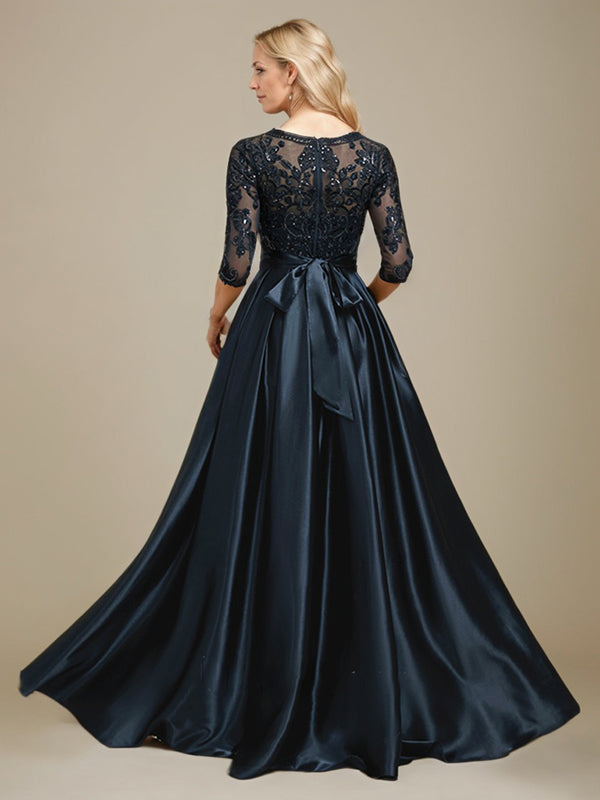 Robe de mariée longue en satin stretch dentelle et dentelle, coupe trapèze, décolleté illusion, ornée d'un nœud à sequins 