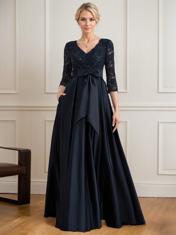 Vestido de novia de satén con encaje, corte en A, escote en V y largo hasta el suelo, con lazo de lentejuelas. 