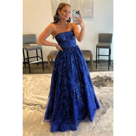 Vestido largo de fiesta de corte A, sin tirantes, con apliques de lentejuelas y bolsillos.