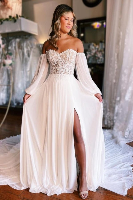 Robe de mariée trapèze bustier cœur manches longues fendue sur le devant avec dentelle