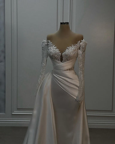 Precioso vestido de novia largo blanco de corte A, encaje y satén, con mangas largas.