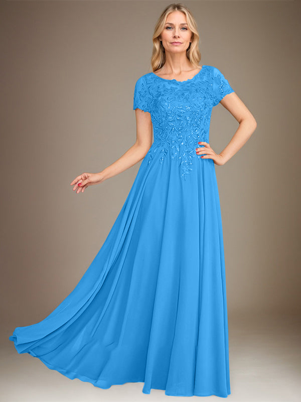 Robe de mariée longue en mousseline de soie, coupe trapèze, décolleté rond, ornée d'appliqués et de sequins, idéale pour la mère de la mariée. 