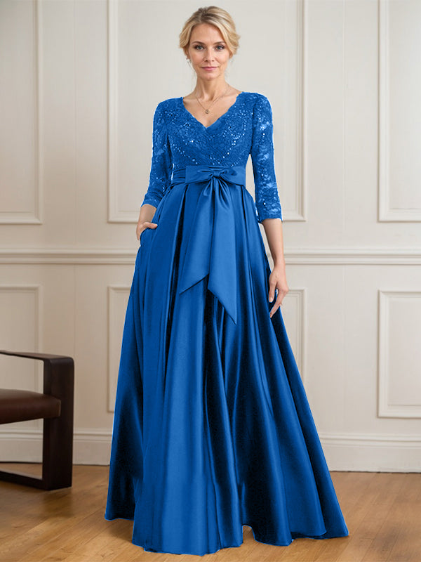 Vestido de novia de satén con encaje, corte en A, escote en V y largo hasta el suelo, con lazo de lentejuelas. 
