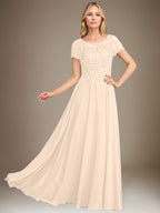 Robe de mariée longue en mousseline de soie, coupe trapèze, décolleté rond, ornée d'appliqués et de sequins, idéale pour la mère de la mariée. 