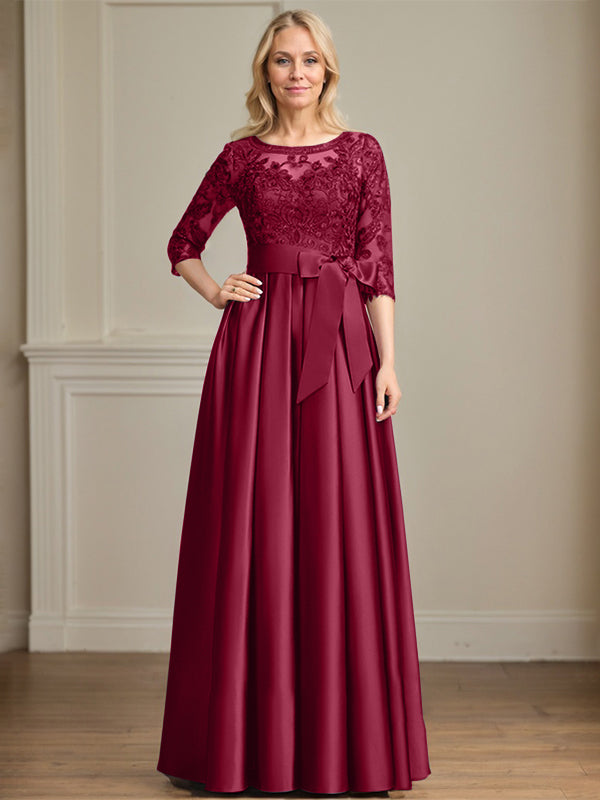 Vestido de novia corte A, escote ilusión, largo hasta el suelo, de satén y encaje, con lazo de lentejuelas. 