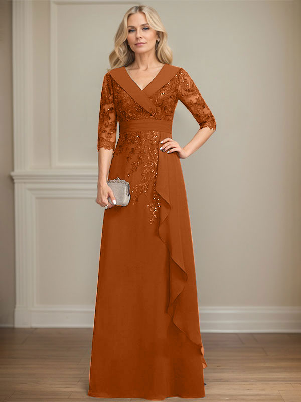 Vestido de novia de corte línea A, cuello en V, largo hasta el suelo, de encaje y gasa, con lentejuelas y volantes en cascada. 