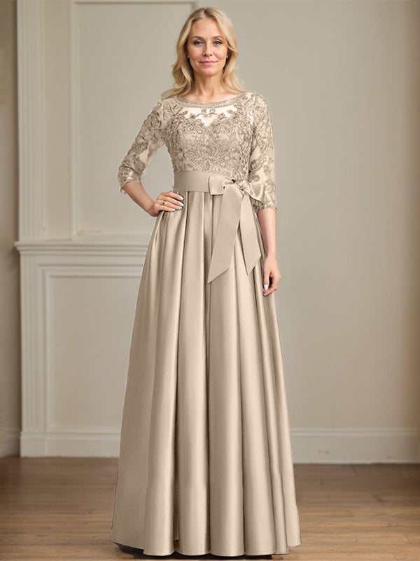 Vestido de novia corte A, escote ilusión, largo hasta el suelo, de satén y encaje, con lazo de lentejuelas. 