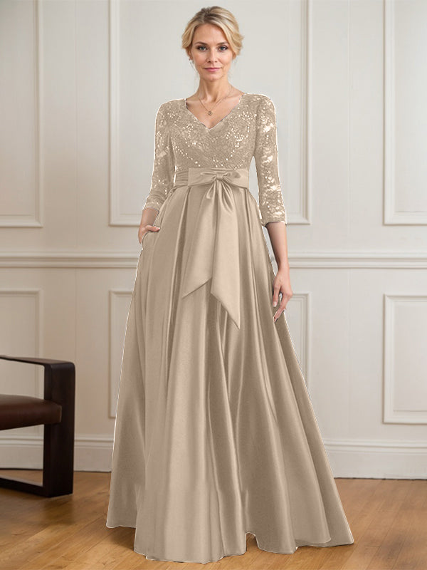Vestido de novia de satén con encaje, corte en A, escote en V y largo hasta el suelo, con lazo de lentejuelas. 