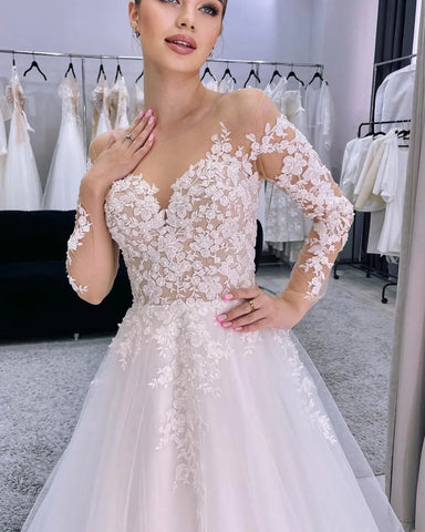 Encantador vestido de novia largo de corte A con apliques de tul y mangas largas