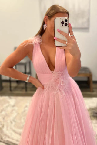 Vestido largo de tul rosa con espalda descubierta, escote en V pronunciado y detalles de plumas.