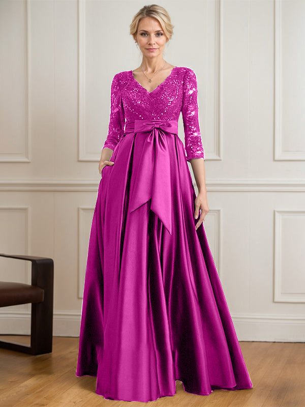 Vestido de novia de satén con encaje, corte en A, escote en V y largo hasta el suelo, con lazo de lentejuelas. 