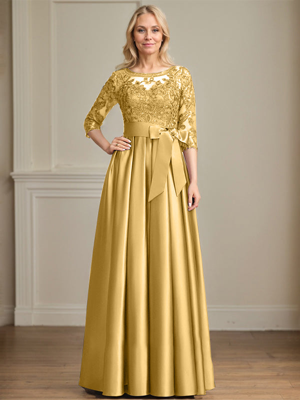 Vestido de novia corte A, escote ilusión, largo hasta el suelo, de satén y encaje, con lazo de lentejuelas. 