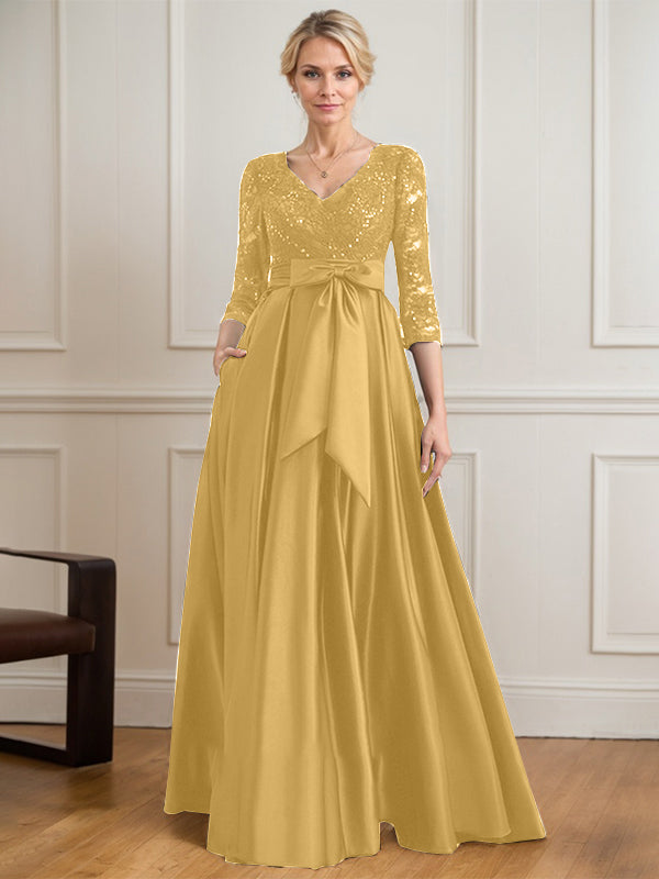 Vestido de novia de satén con encaje, corte en A, escote en V y largo hasta el suelo, con lazo de lentejuelas. 
