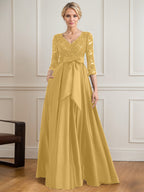 Vestido de novia de satén con encaje, corte en A, escote en V y largo hasta el suelo, con lazo de lentejuelas. 