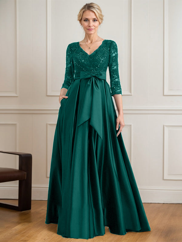 Vestido de novia de satén con encaje, corte en A, escote en V y largo hasta el suelo, con lazo de lentejuelas. 