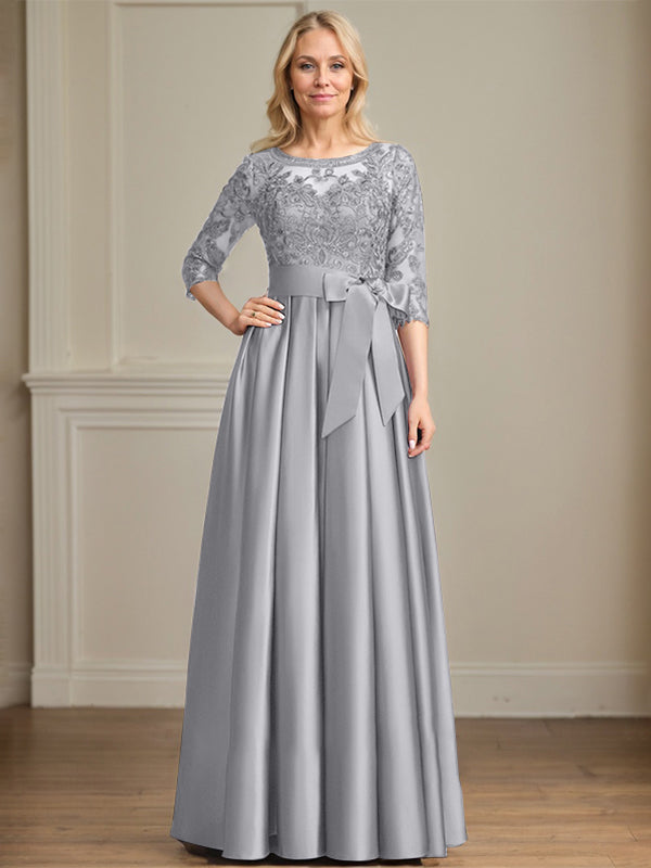 Vestido de novia corte A, escote ilusión, largo hasta el suelo, de satén y encaje, con lazo de lentejuelas. 