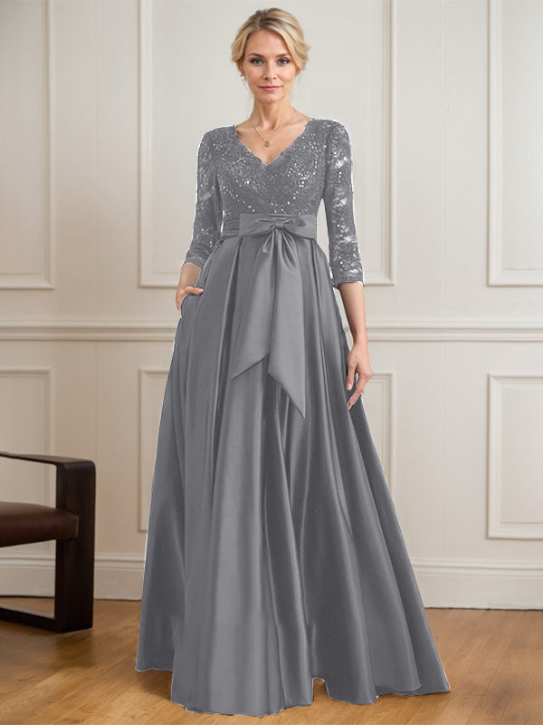 Vestido de novia de satén con encaje, corte en A, escote en V y largo hasta el suelo, con lazo de lentejuelas. 