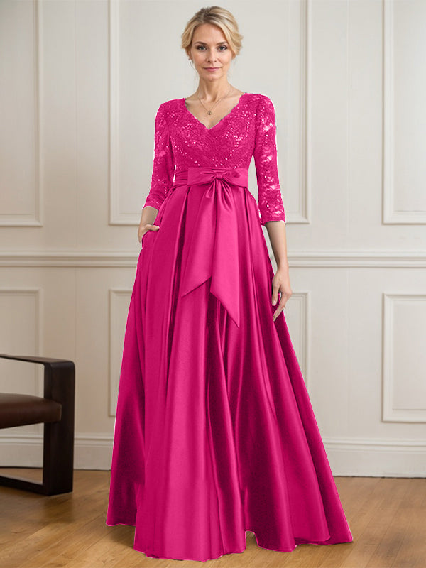 Vestido de novia de satén con encaje, corte en A, escote en V y largo hasta el suelo, con lazo de lentejuelas. 